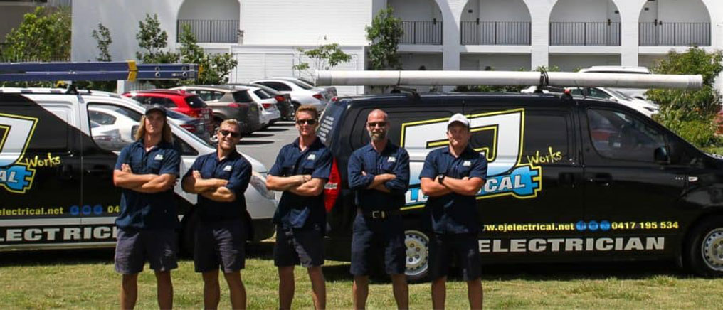 The EJ Electrical team with their vans on the Gold Coast